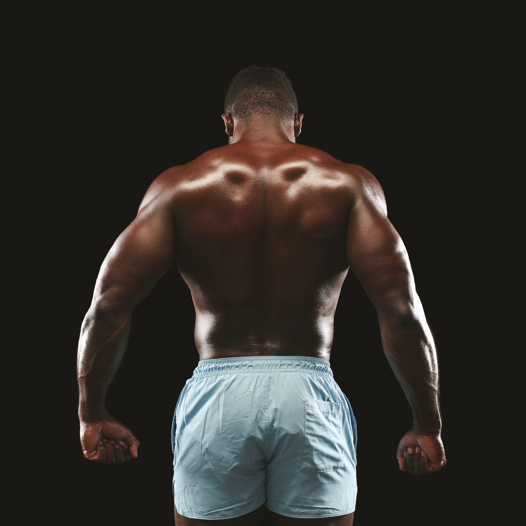 African american sportsman showing strong back muscles